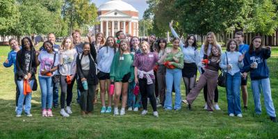 Group of VCAC-served students standing on UVA's lawn, with the Rotunda in the background.
