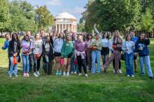 Group of VCAC-served students standing on UVA's lawn, with the Rotunda in the background.